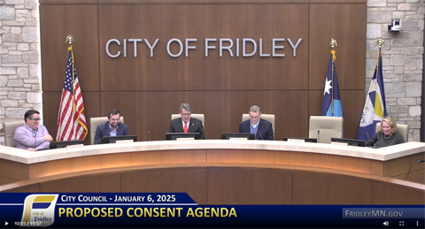 Council members sitting at table in council chambers