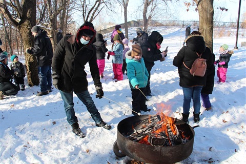 People around a fire at Winterfest