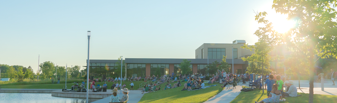 People sitting at the outdoor amphitheater for a concert