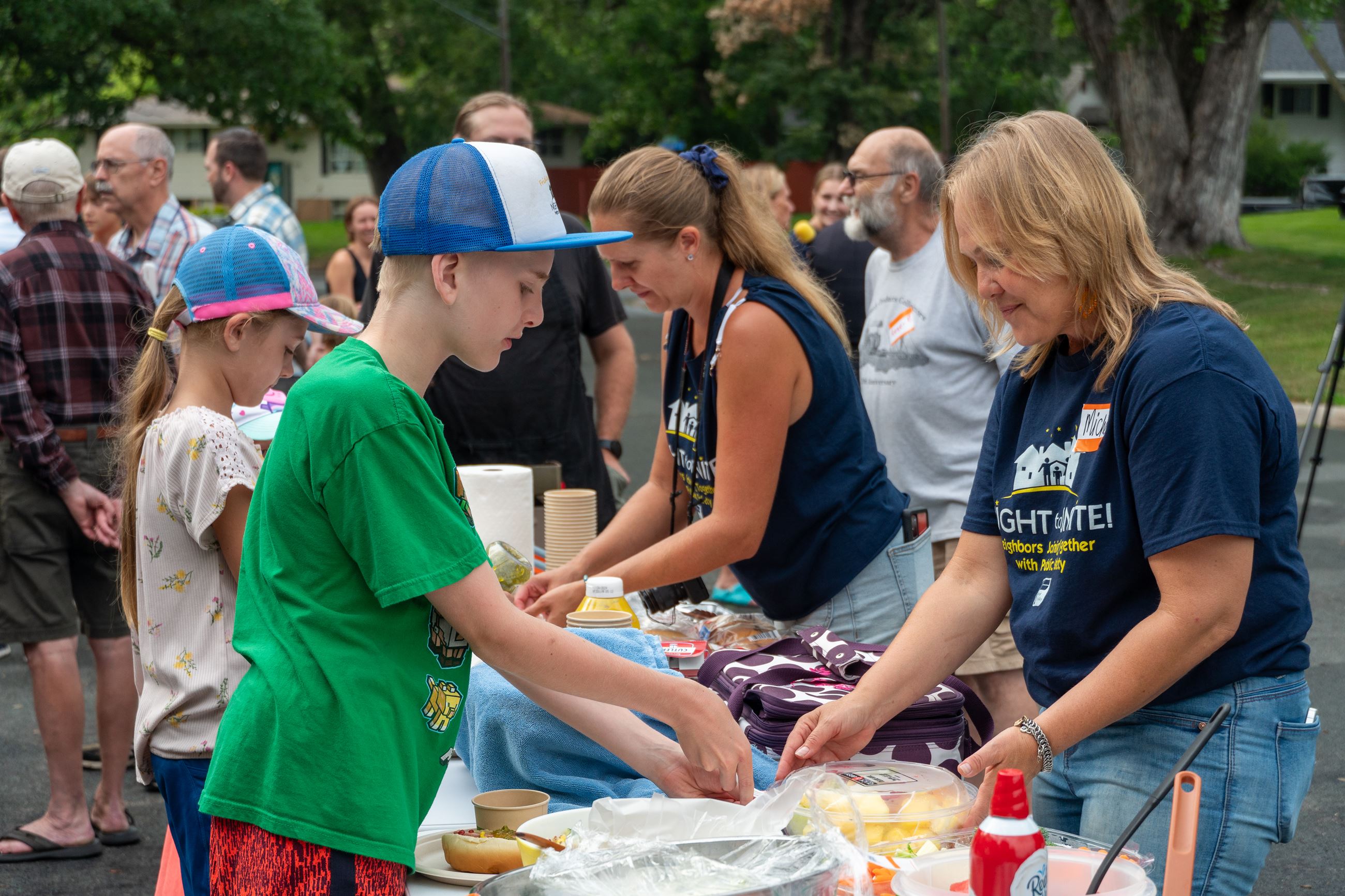 People getting food at a Night to Unite Party